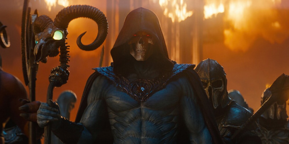 Figure squelettique avec capuche et bâton, fond de feu et personnages casqués.