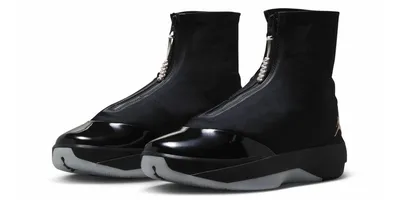 Chaussures noires élégantes avec zip central et bout verni.