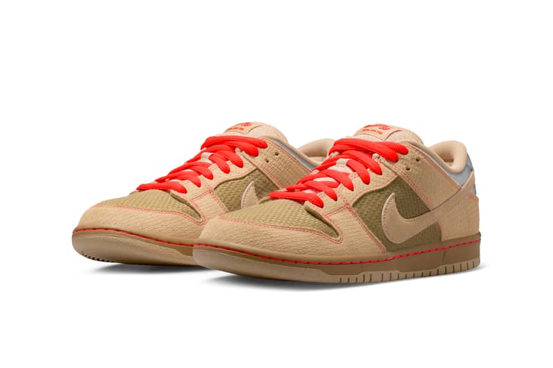 Baskets basse beige avec accents rouges et logo Nike.