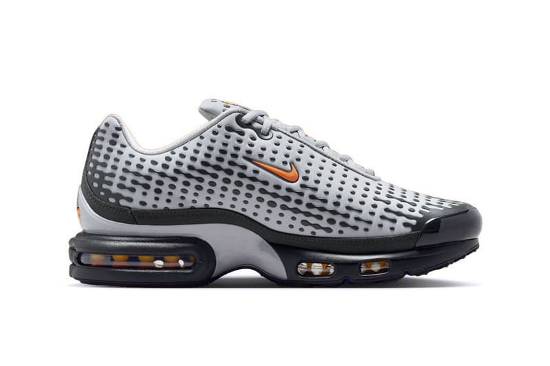 Chaussure de sport grise et noire avec logo orange visible
