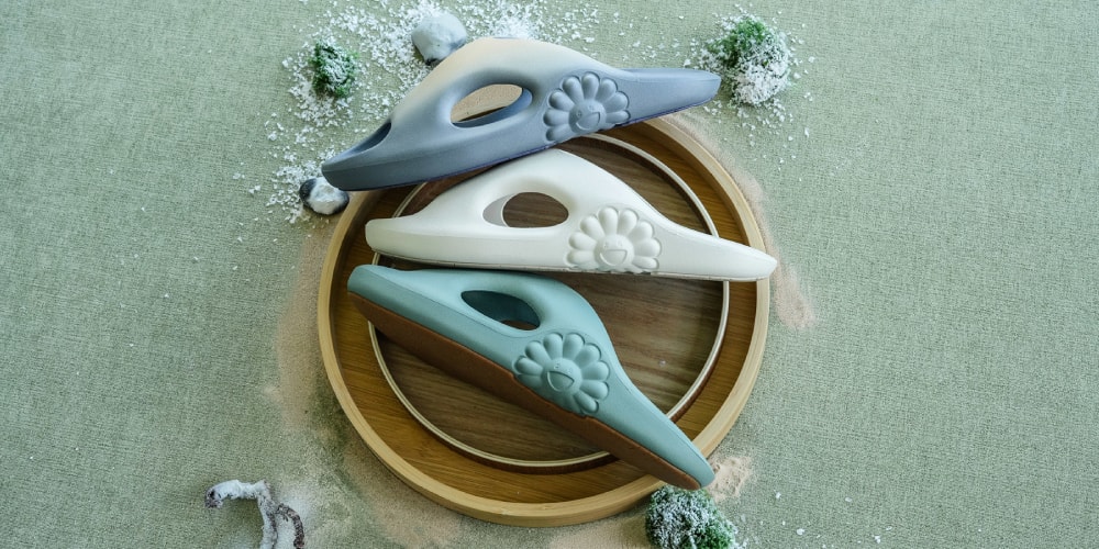 Trois chaussures colorées sur un plateau rond en bois sur fond vert