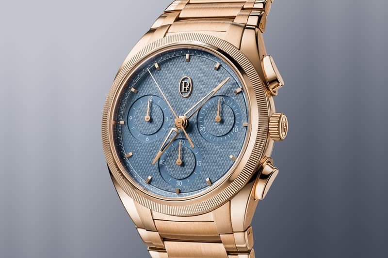 Montre en or rose avec cadran bleu et trois petits sous-cadrans, bracelet en métal.