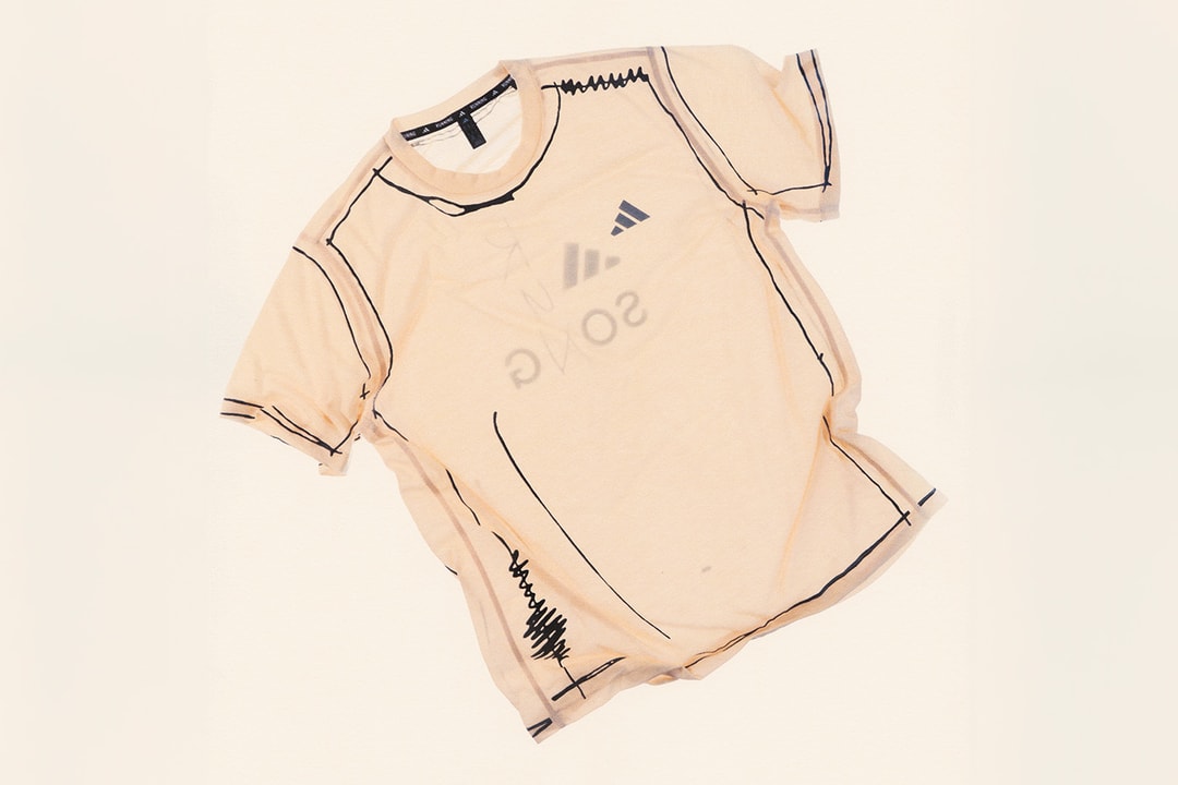 T-shirt beige avec motifs noirs et logo illisible