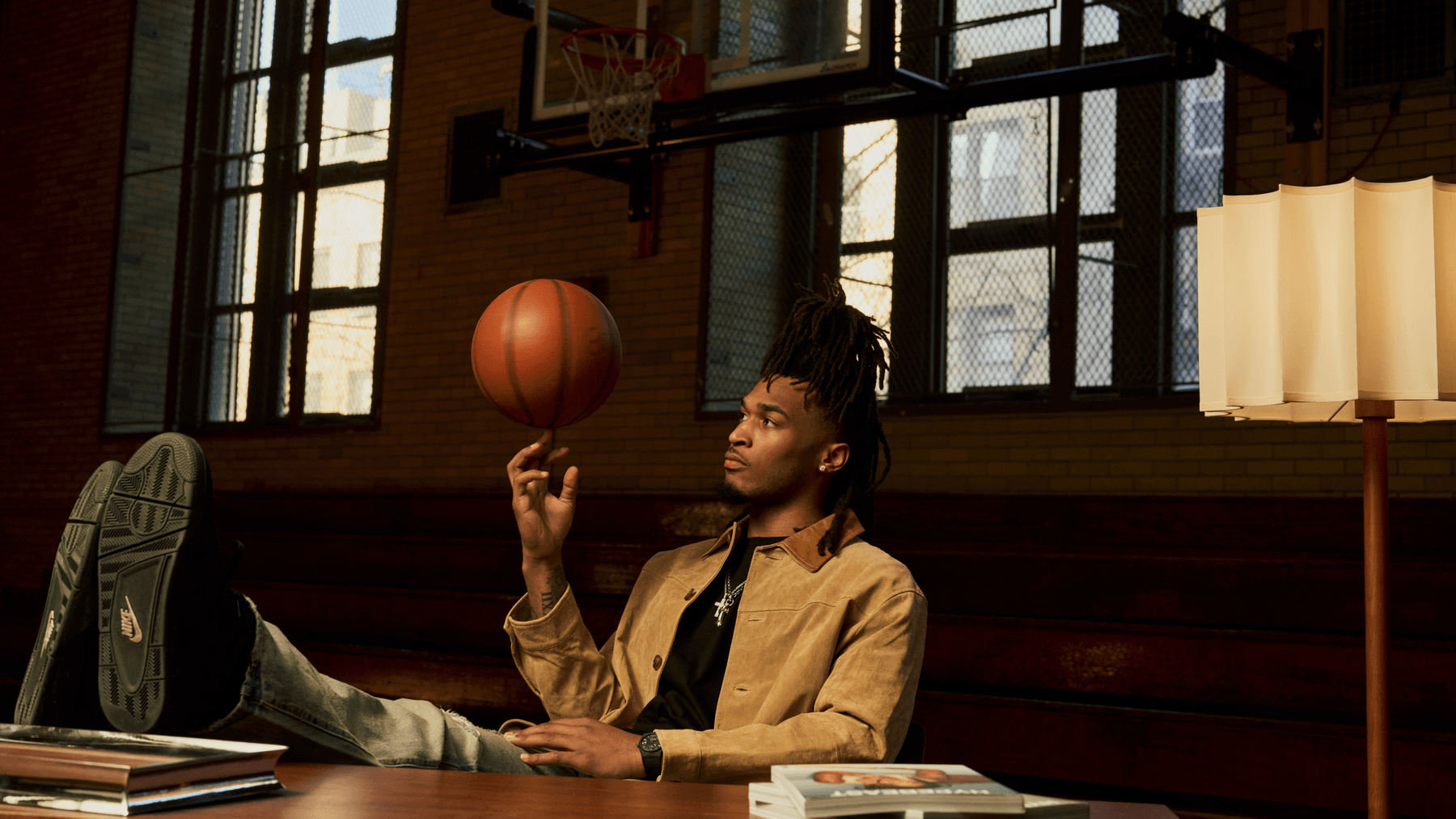 Homme jonglant avec un ballon de basket dans un gymnase.