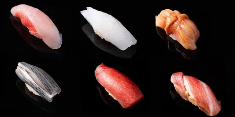 Sushi varié sur fond noir, six pièces différentes captivantes.