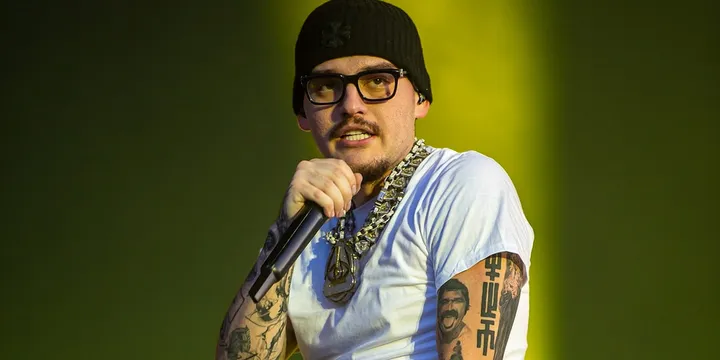 Chanteur en lunettes et bonnet noir sur scène