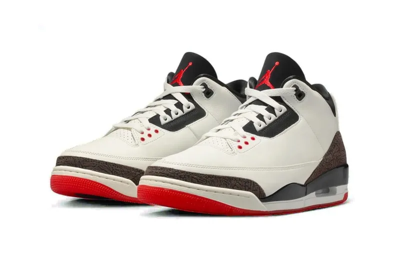 Chaussures de sport blanches et rouges avec détails noirs et motifs.
