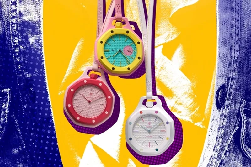 Trois montres colorées suspendues sur fond abstrait jaune et bleu.
