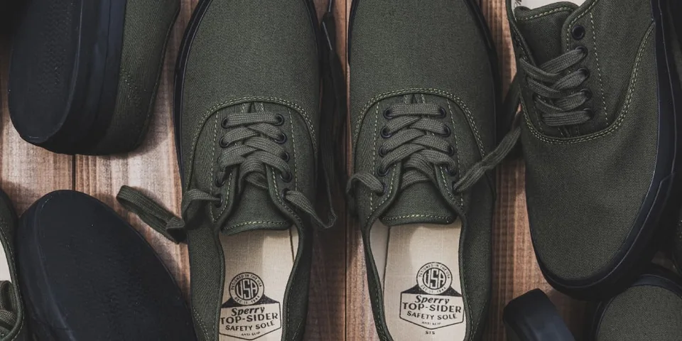 Chaussures vertes Sperry Top-Sider sur fond en bois.