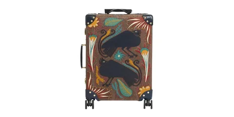Valise avec motifs décoratifs de plumes et créatures noires.