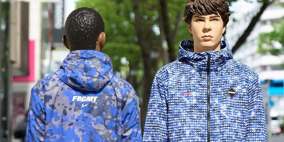 Deux mannequins portant des vestes bleues à motifs sur un fond urbain.