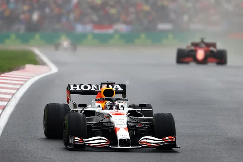 Voiture de course Honda sur piste mouillée pendant une course de Formule 1.