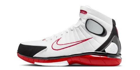 Chaussure de sport blanche avec accents rouges et noirs, design moderne.