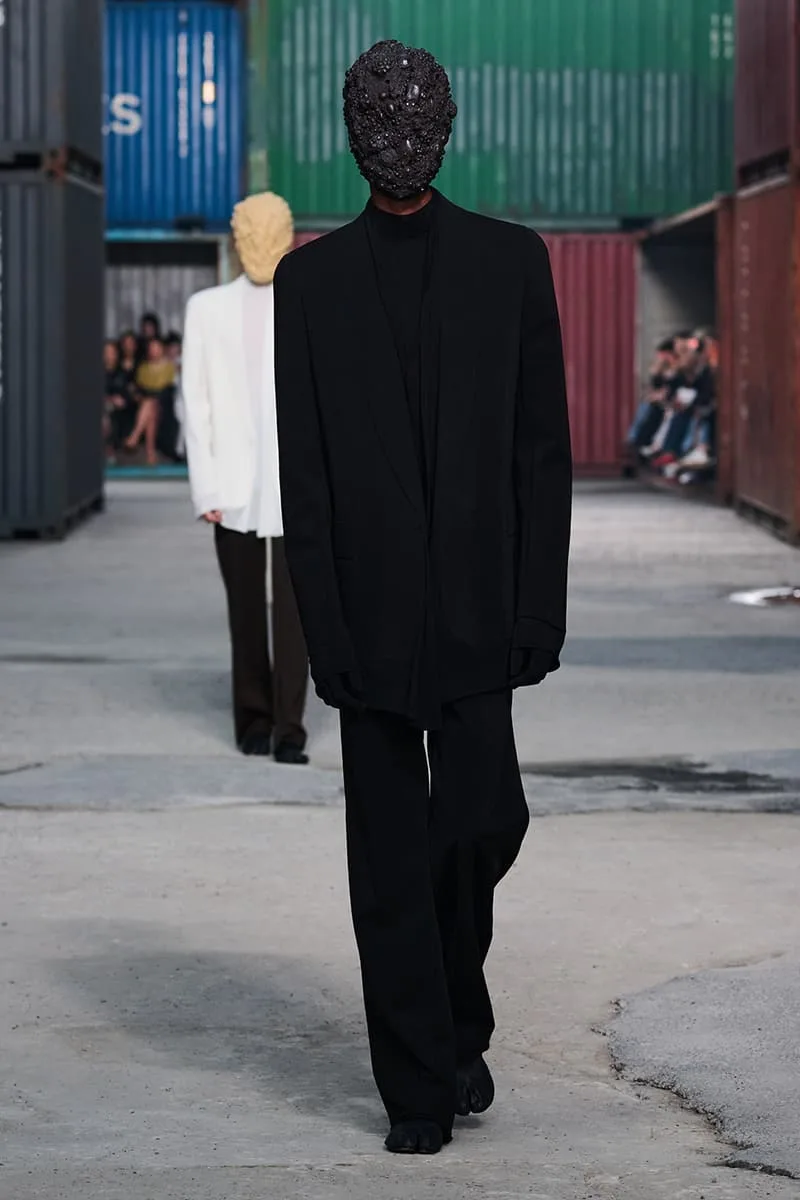 Collection Maison Margiela FW26 à la Shanghai Fashion Week par Glenn Martens : Maison Margiela FW26 apporte un marché aux puces parisien dans un chantier naval de Shanghai, prêt-à-porter artisanal