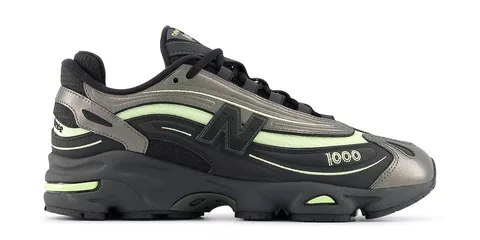 Baskets New Balance noires et vertes avec détails futuristes.