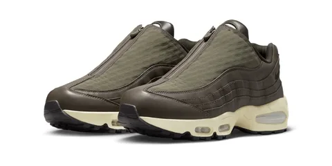 Chaussures de sport marron avec fermeture éclair, semelles crèmes et bulles d'air.