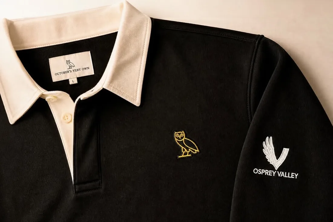 Polo noir avec logos de hibou et Osprey Valley.