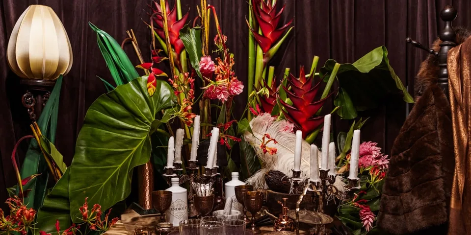 Arrangement floral vibrant avec bougies et objets vintage.