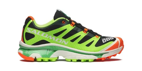 Chaussure de sport verte et orange Salomon avec logo visible.