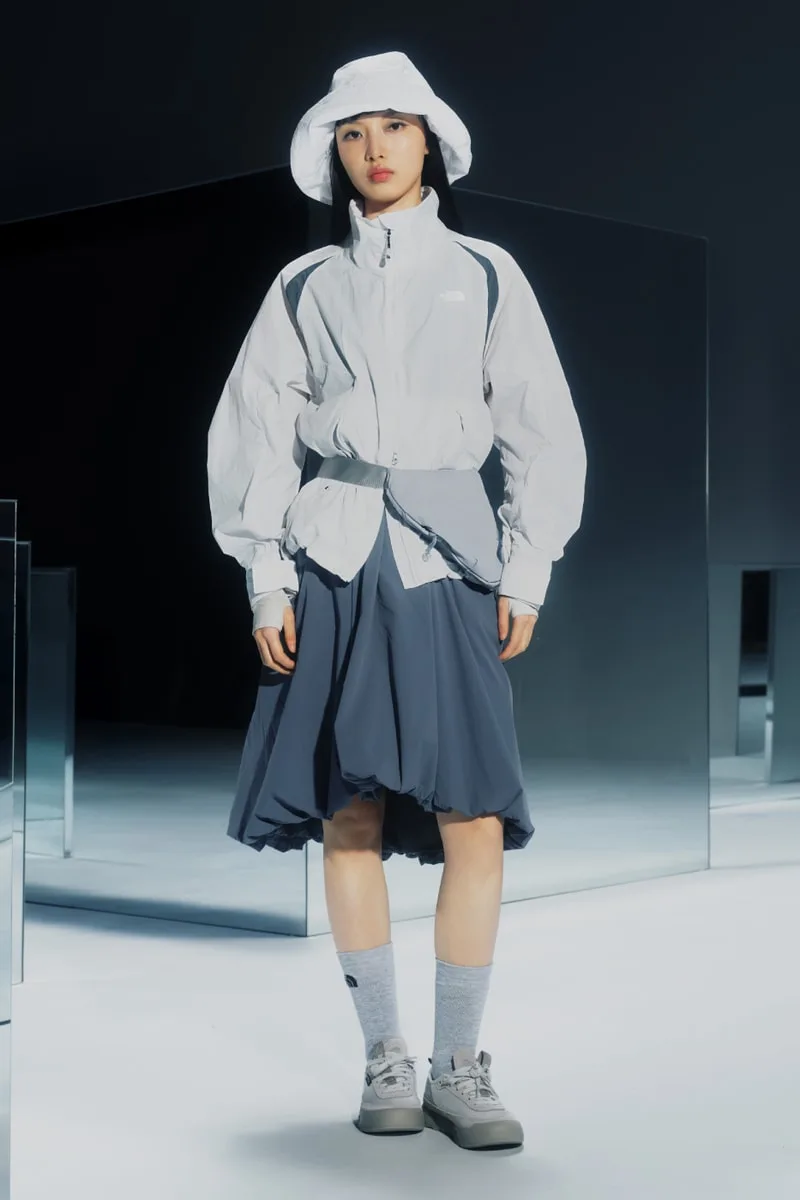 Personne en tenue sportive élégante avec chapeau blanc.