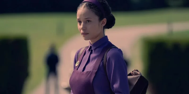 Femme en tenue violette avec sac à dos, fond flou de parc