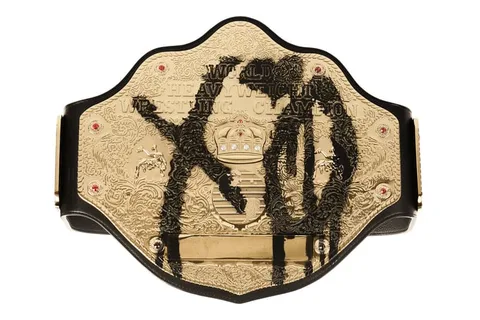 Ceinture de champion de lutte dorée avec des graffitis noirs.